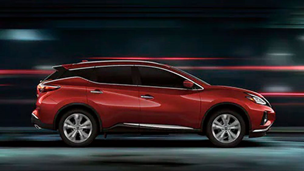 2023 Nissan Murano shown in profile driving down a street at night illustrating performance. | Monken Nissan in Centralia IL